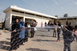 Syrian refugee women in northern Lebanon display a 100 metre fishing net that they've made, as part of a livelihoods training project supported by UK aid. Training women in skills that are needed locally is one way in which Syrian refugees are being supported in Lebanon. The