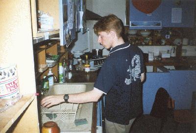 1: Mark cleaning the kitchen